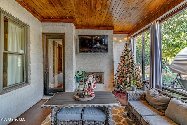 sunroom featuring an outdoor fireplace and wooden ceiling