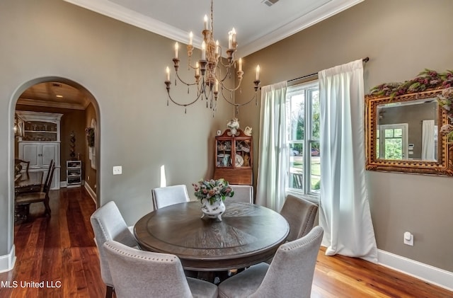 dining area with a notable chandelier, dark hardwood / wood-style flooring, crown molding, and wine cooler