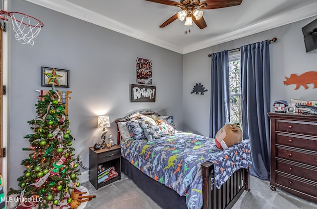 carpeted bedroom featuring ceiling fan and ornamental molding