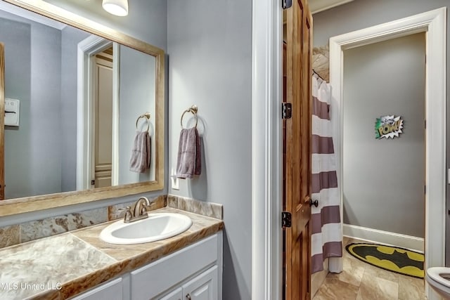 bathroom featuring vanity, a shower with shower curtain, and toilet