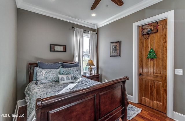 bedroom with ceiling fan, ornamental molding, and light wood-type flooring