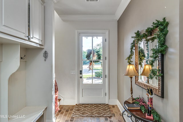 entryway featuring crown molding