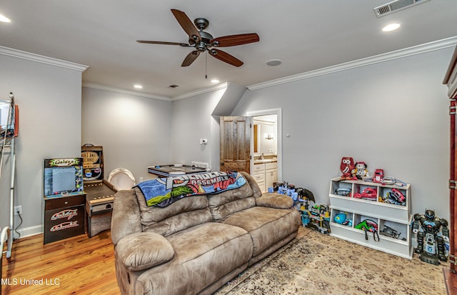 living room featuring light wood-type flooring, ceiling fan, and ornamental molding