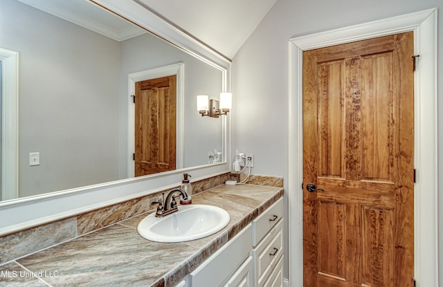 bathroom featuring vanity and lofted ceiling