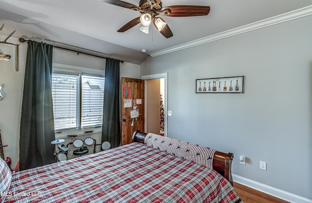 bedroom with hardwood / wood-style flooring, ceiling fan, and crown molding