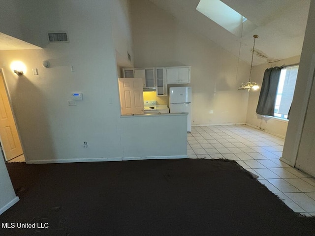 unfurnished living room featuring a skylight, a chandelier, visible vents, light tile patterned flooring, and high vaulted ceiling