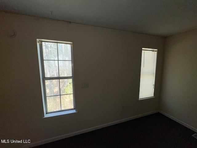 spare room featuring baseboards