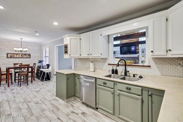 5751 Orchardview Dr, Jackson, MS 39211 - kitchen featuring stainless steel dishwasher, green cabinets, a sink, crown molding, and decorative backsplash