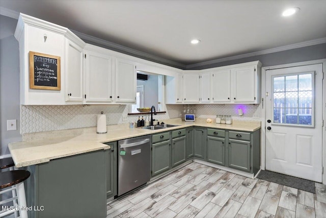 5751 Orchardview Dr, Jackson, MS 39211 - kitchen featuring stainless steel dishwasher, a sink, white cabinets, tasteful backsplash, and crown molding
