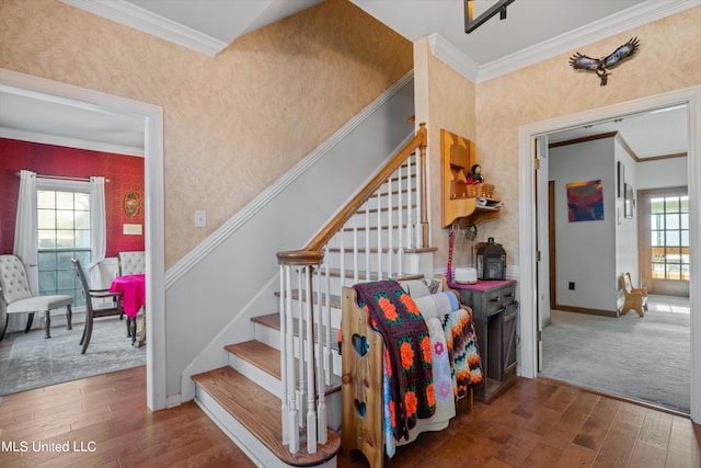 stairway featuring ornamental molding and hardwood / wood-style flooring