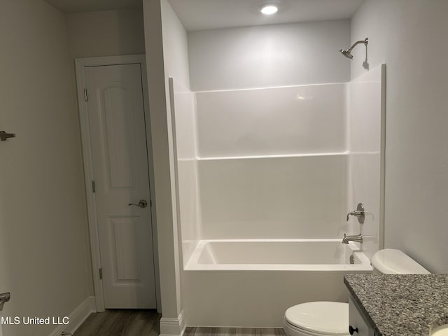 full bathroom with hardwood / wood-style flooring, vanity, shower / bathing tub combination, and toilet