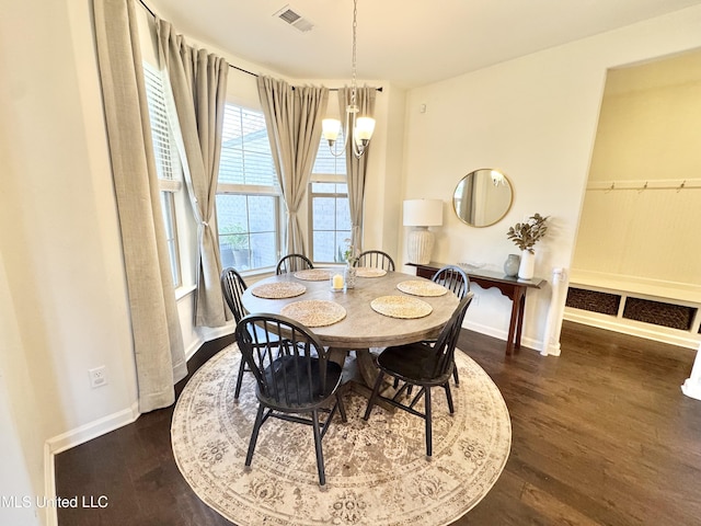 dining room with an inviting chandelier, baseboards, dark wood-type flooring, and visible vents