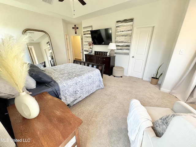 carpeted bedroom with visible vents and a ceiling fan