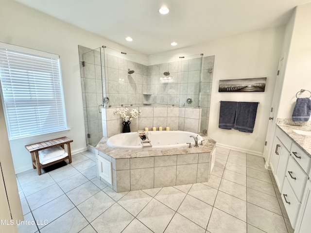bathroom with a whirlpool tub, baseboards, tile patterned flooring, and a stall shower