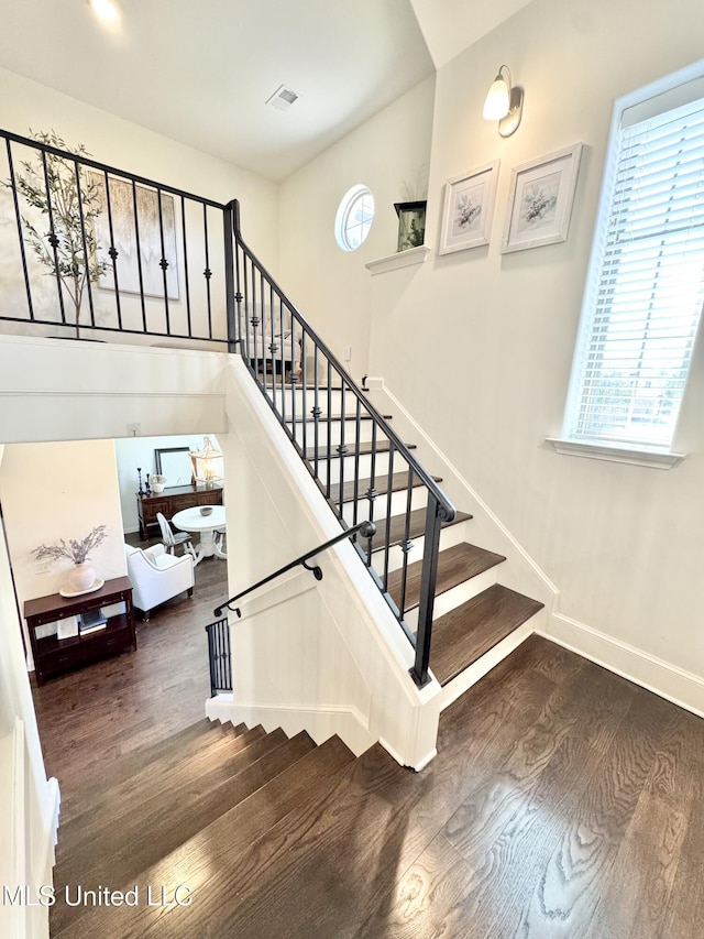 stairs featuring baseboards and wood finished floors