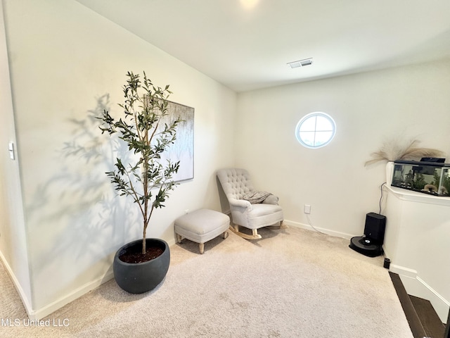 living area featuring carpet flooring, baseboards, and visible vents