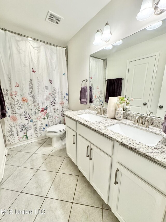 full bathroom featuring a sink, toilet, visible vents, and tile patterned floors