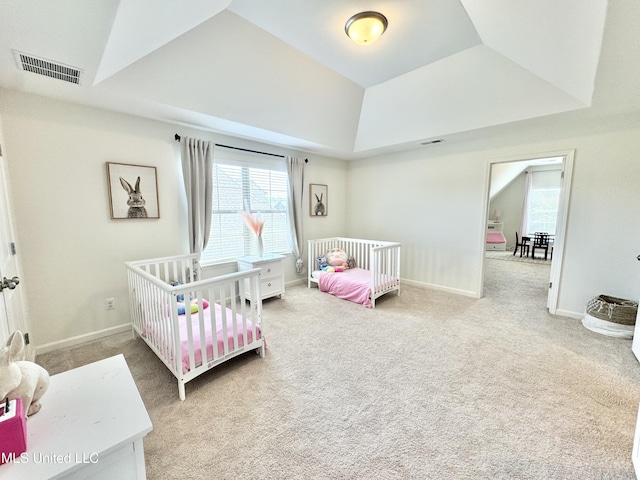 bedroom featuring multiple windows, visible vents, and carpet