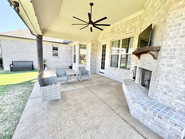 view of patio / terrace with an outdoor brick fireplace and ceiling fan