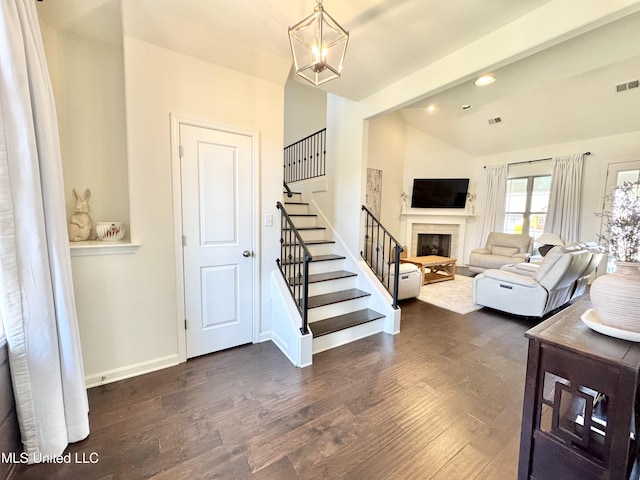 interior space featuring baseboards, visible vents, wood finished floors, and a fireplace