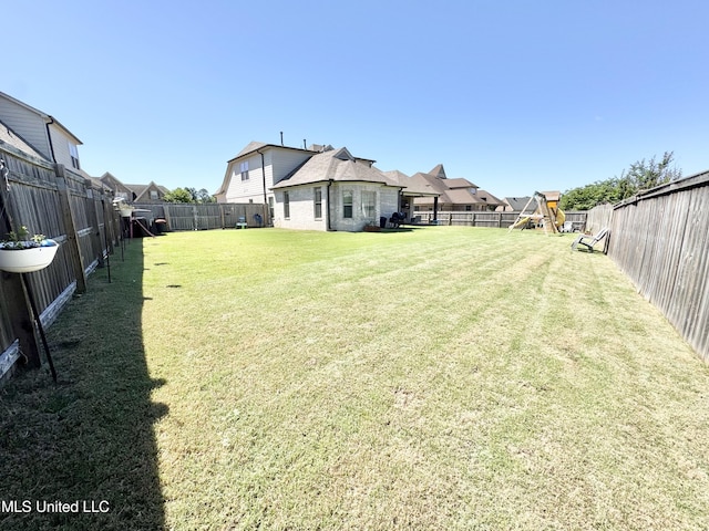 view of yard with a playground, a residential view, and a fenced backyard