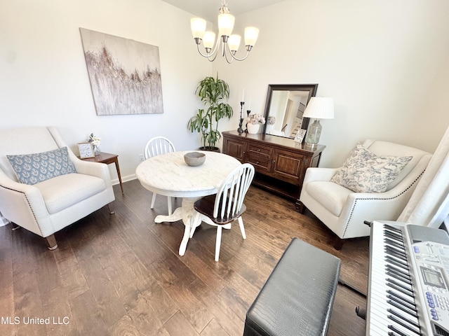 dining area with dark wood-style flooring, baseboards, and a notable chandelier
