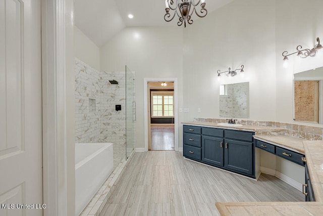 bathroom with vanity, high vaulted ceiling, wood-type flooring, and plus walk in shower