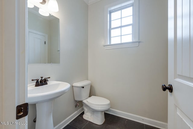 bathroom with toilet, ornamental molding, sink, and tile patterned flooring