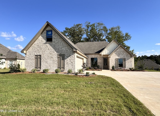 view of front of house with a front yard and a garage