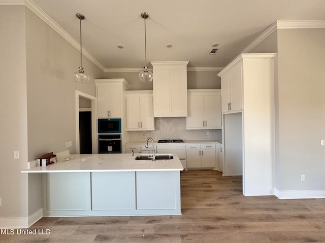 kitchen with light wood-style flooring, oven, a sink, backsplash, and built in microwave