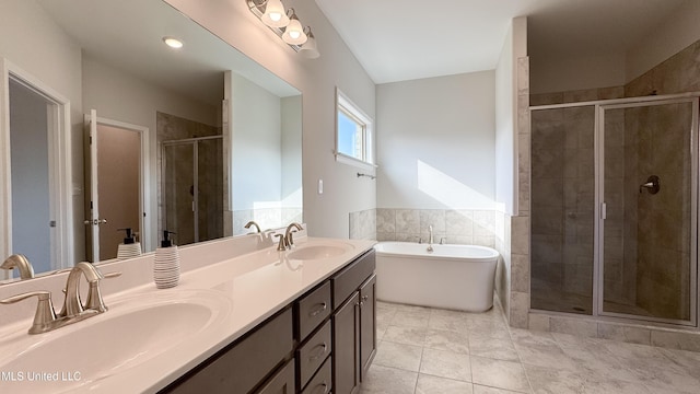 bathroom featuring tile patterned flooring, vanity, and shower with separate bathtub