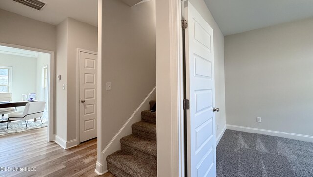 stairway with hardwood / wood-style flooring