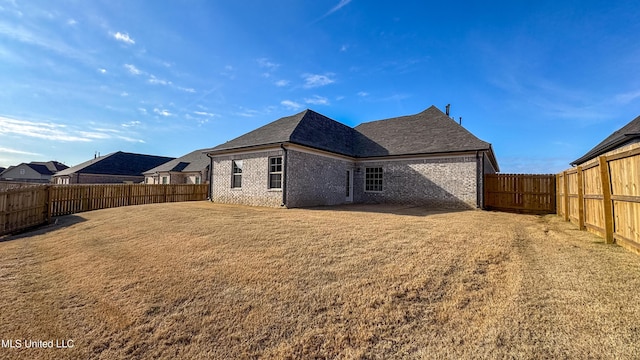 back of property featuring a lawn