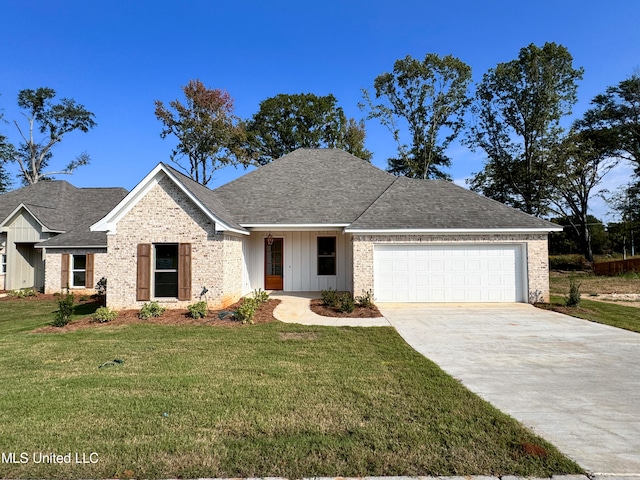 view of front of house with a garage and a front lawn