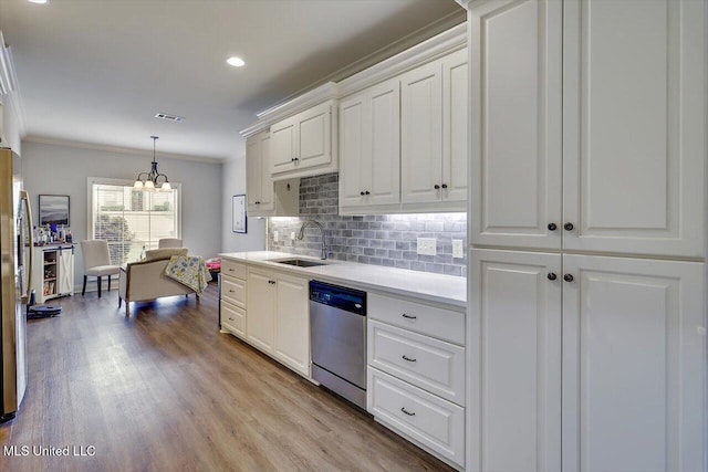 106 Sumter Dr, Canton, MS 39046 - kitchen with appliances with stainless steel finishes, a sink, crown molding, backsplash, and white cabinetry