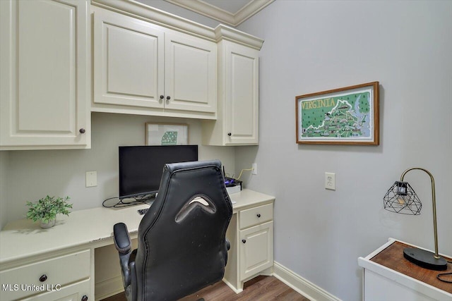 106 Sumter Dr, Canton, MS 39046 - home office with built in desk, wood finished floors, baseboards, and ornamental molding