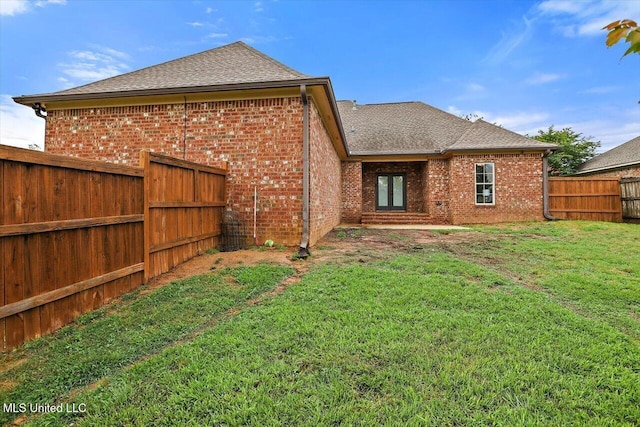 106 Sumter Dr, Canton, MS 39046 - back of house featuring a shingled roof and brick siding