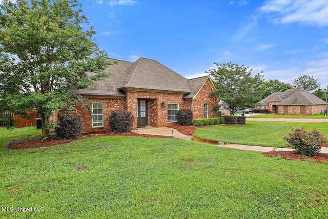 106 Sumter Dr, Canton, MS 39046 - view of front of home with a front yard, brick siding, and roof with shingles