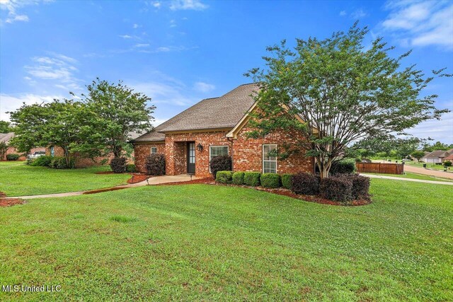 106 Sumter Dr, Canton, MS 39046 - traditional-style home featuring brick siding and a front lawn