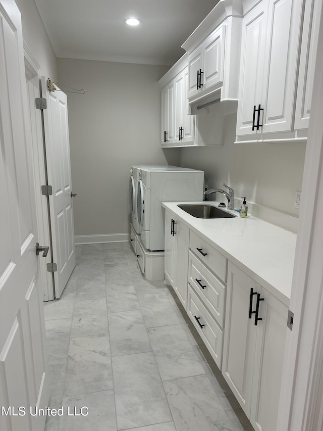 laundry area with cabinets, sink, and washing machine and clothes dryer