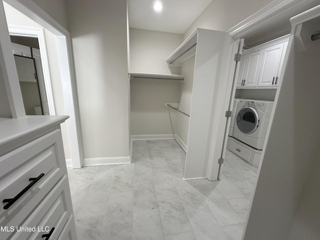 washroom featuring washer / dryer and cabinets