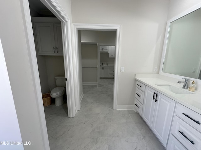 bathroom featuring vanity and toilet