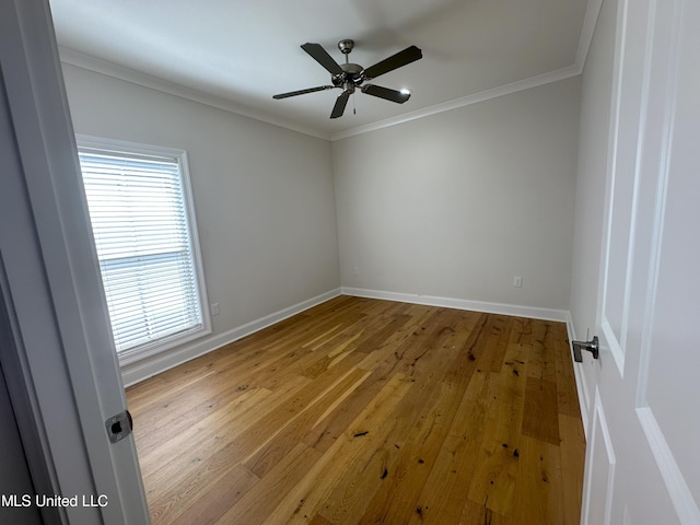 empty room featuring crown molding, hardwood / wood-style flooring, and ceiling fan