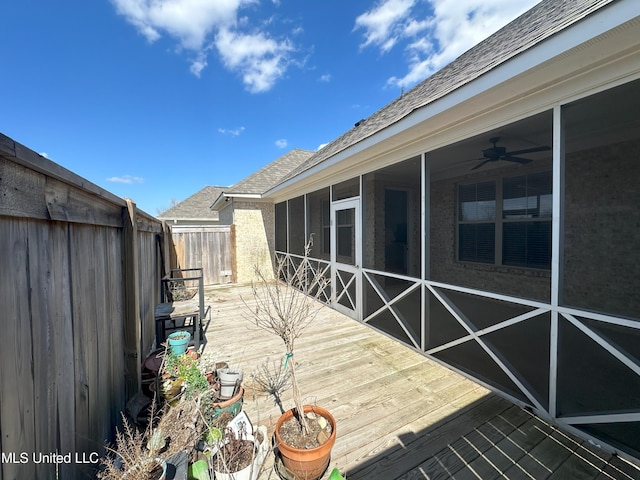 deck featuring a sunroom and ceiling fan