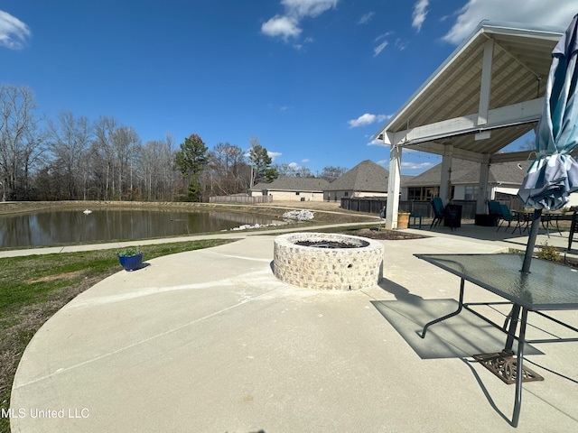 view of patio / terrace featuring a water view and an outdoor fire pit