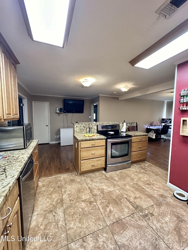 kitchen with visible vents, baseboards, light stone counters, and stainless steel appliances