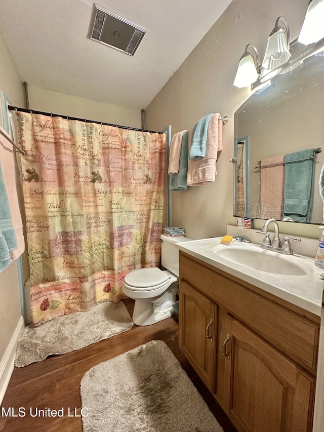 full bath with visible vents, vanity, wood finished floors, toilet, and a shower with shower curtain