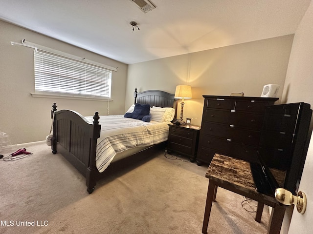 bedroom featuring light colored carpet and visible vents