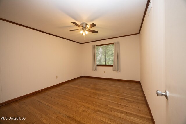 spare room featuring crown molding, hardwood / wood-style flooring, and ceiling fan