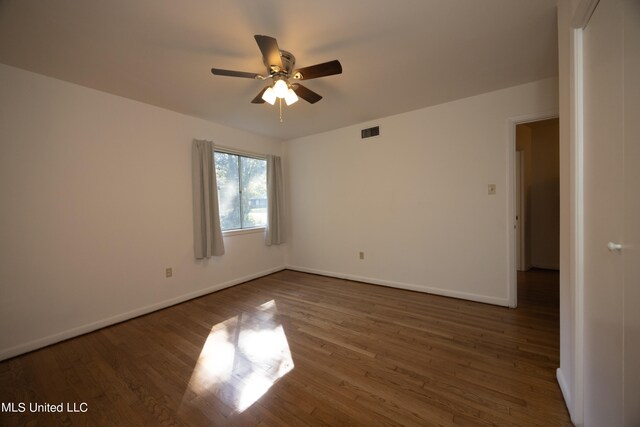 unfurnished room featuring ceiling fan and dark hardwood / wood-style flooring